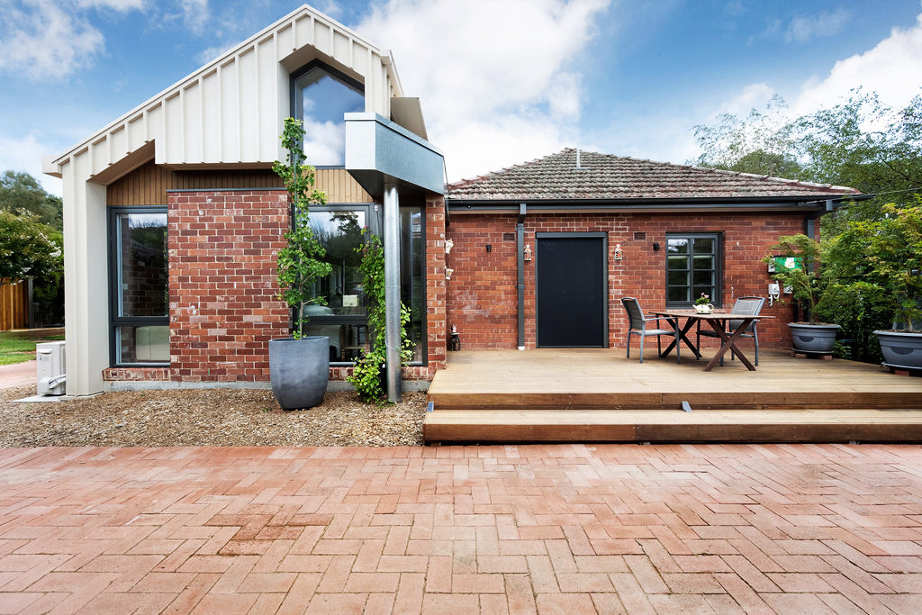 Modern extension to a brick home with timber deck in Canberra
